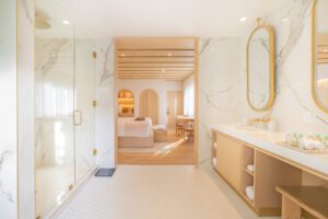 best boutique hotel near art deco district luxury suite Interior view of a luxury suite with marble bathroom and wood accents at Donatella Hotel, the best boutique hotel near Art Deco District