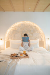honeymoon suite miami romantic breakfast Woman enjoying breakfast in bed in a stone arch suite at Donatella Hotel, the most instagrammable honeymoon suite Miami offers for couples